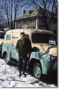 Bill McCallum, the inaugural branch manager of the Toronto branch (left), and Ted Bezance, a skilled service technician who joined after returning from the war (right), stand beside an International Harvester truck.